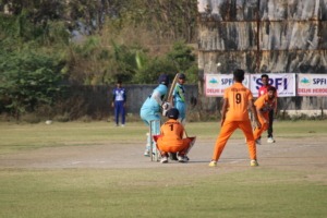 Cricketer hitting the ball on the field during a match