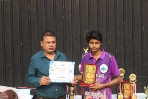 Cricketer receiving achievement certificate